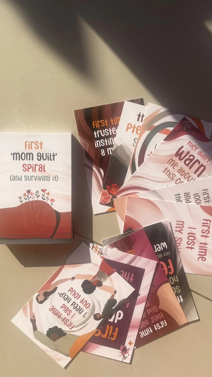 A boxed set of milestone cards with the cards fanned out beside it