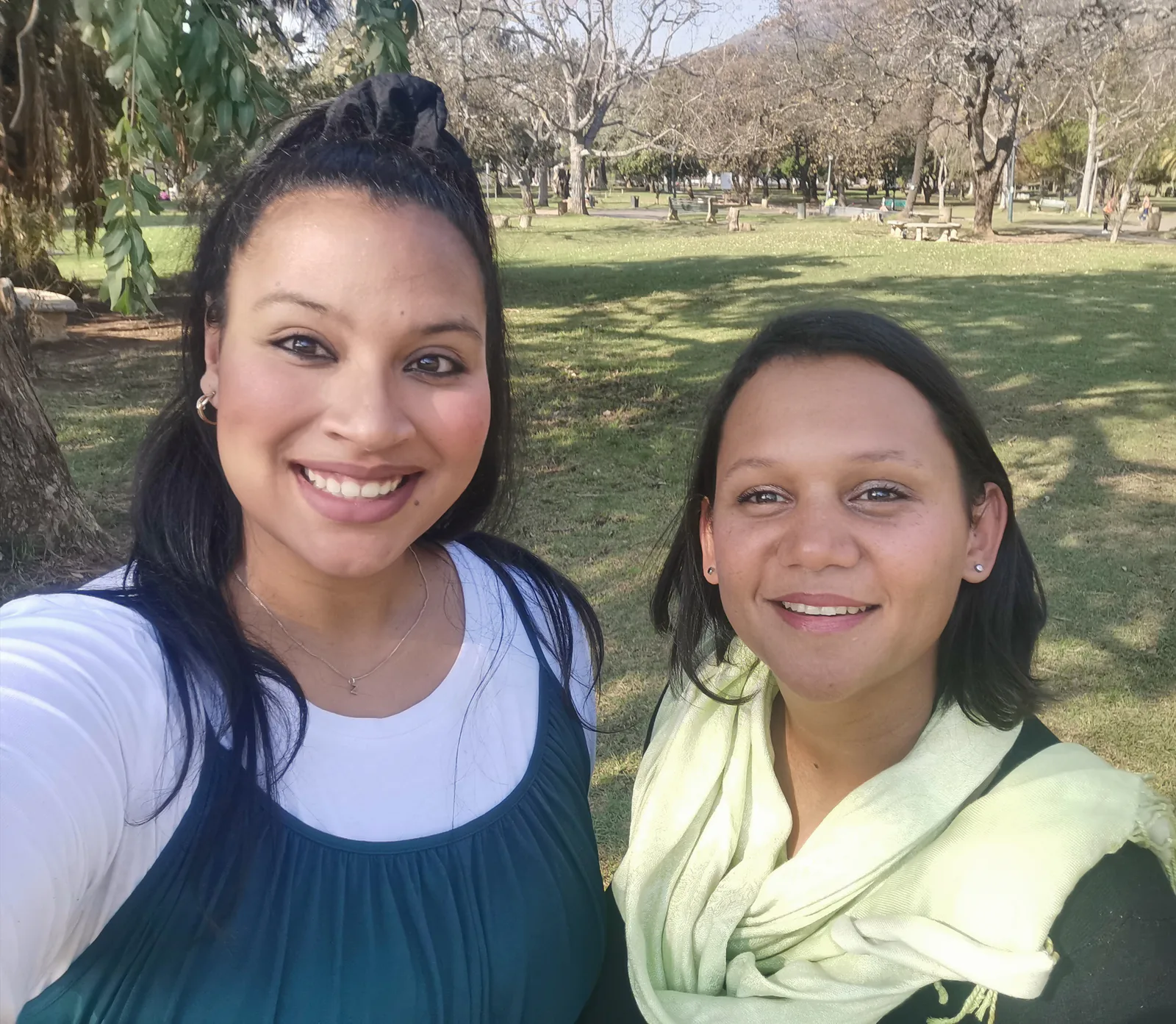 Two members of the Origin Physiotherapy team outdoors in a park